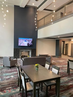 Bright common area with seating and a fireplace