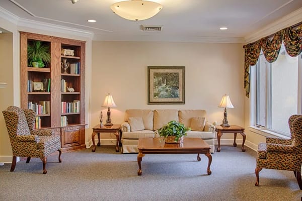 Comfortable common area with seating and bookshelves