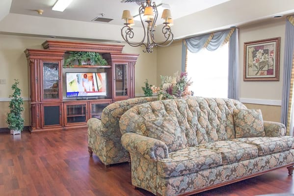 Common area with floral couch and TV