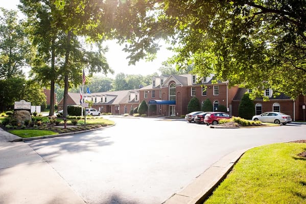 Exterior view of a senior living facility with landscaped entrance