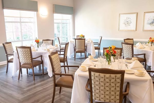 Elegant dining room setup with tables and floral centerpieces