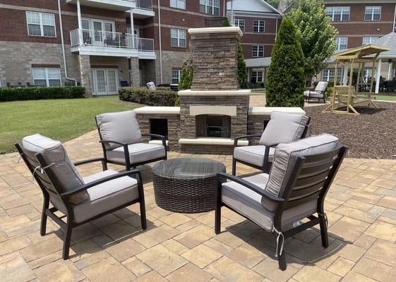 Comfortable seating area with fireplace in outdoor space