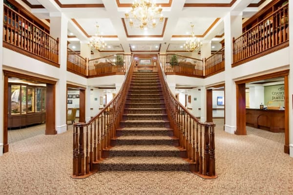 Staircase in the lobby of Courtyard at Jamestown Assisted Living