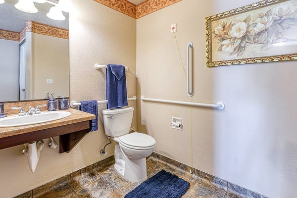 Clean bathroom interior with safety features and decor