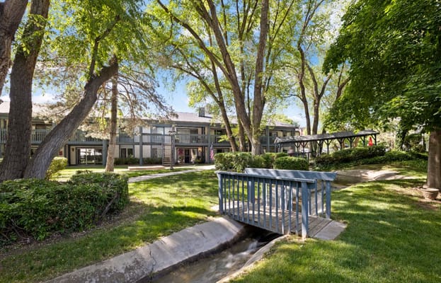 Garden area with a wooden bridge in Cove Point Retirement