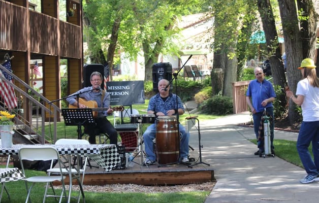 Two musicians performing outdoors at Cove Point Retirement.