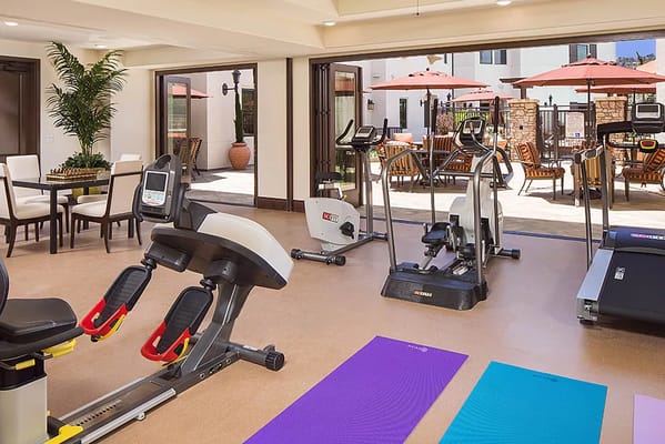 Fitness equipment in the Crestavilla gym with outdoor seating visible