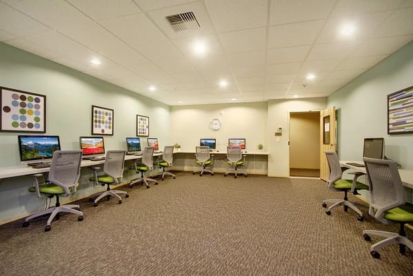 Bright computer room with desks and chairs