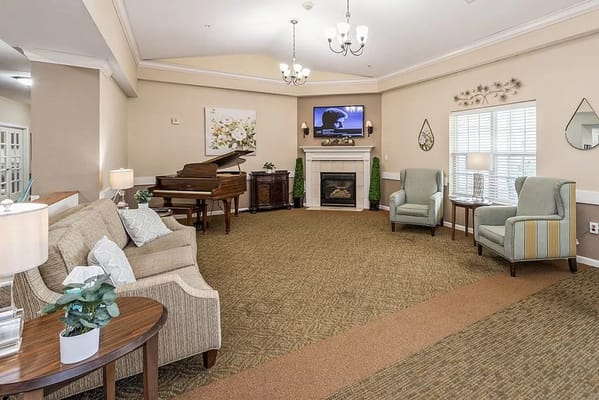 Comfortable seating area with a fireplace and piano