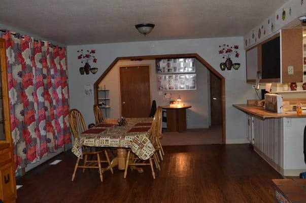 Cozy dining area with wooden furniture and floral curtains