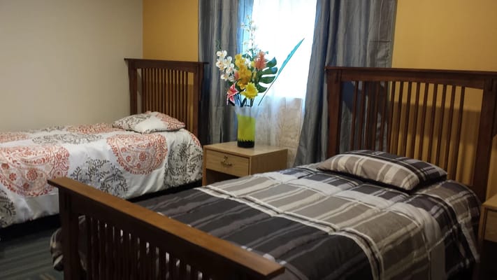 A cozy shared resident room with two beds