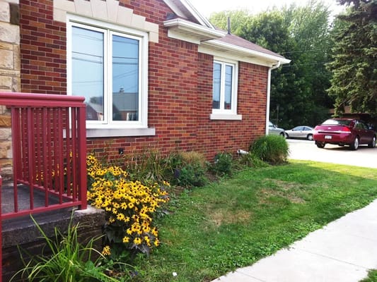 Side view of a brick building with flowers