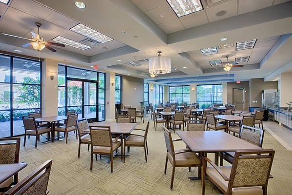 Spacious dining area with tables and chairs at Excellence Senior Living