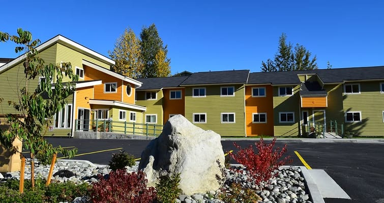 Exterior view of the Campbell Creek House with colorful siding and landscaping.
