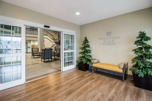 Welcoming entrance area with seating and greenery