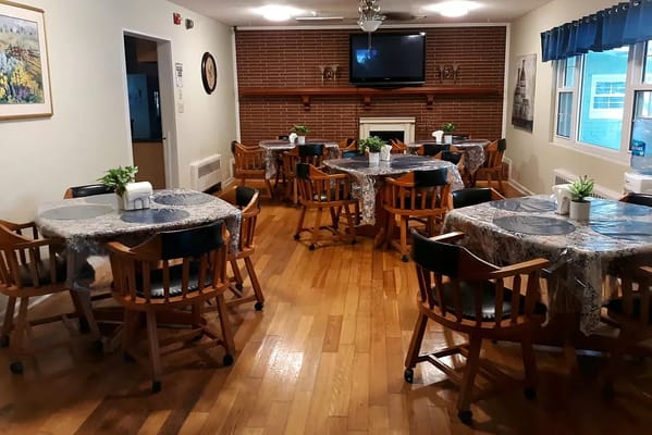 Dining area with tables and chairs set for meals