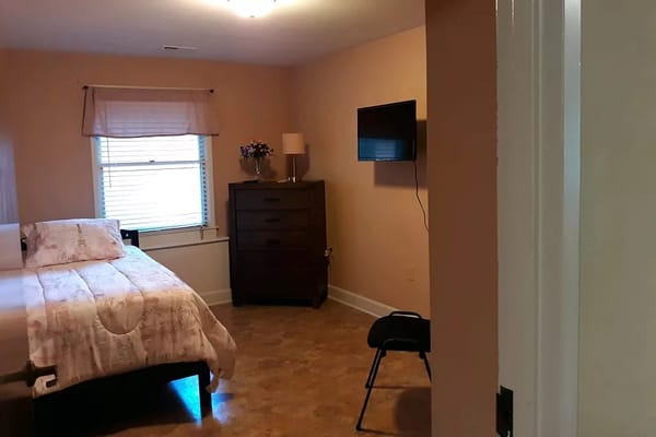 Private resident room with a bed and TV