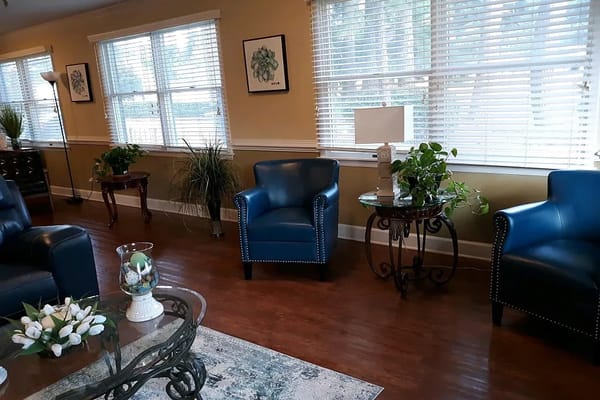 Cozy common area with blue chairs and natural lighting
