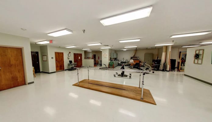 Interior view of a rehabilitation exercise area with equipment
