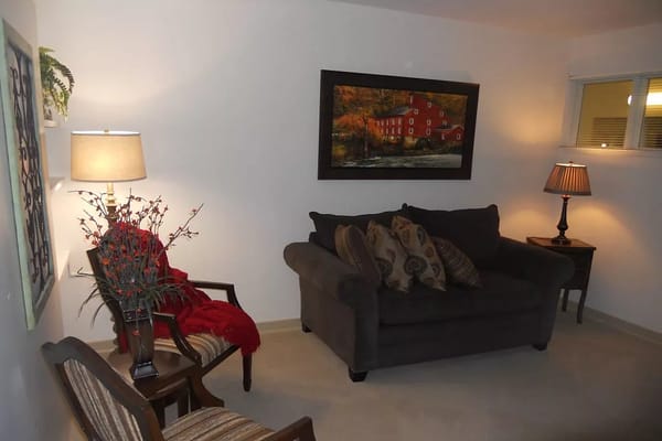 Cozy corner of a living room with a couch and artwork