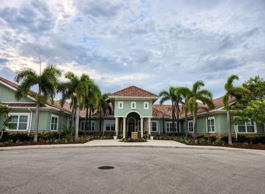 Exterior view of Gulf Coast Memory Care facility with palm trees