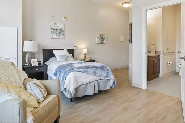 Private resident room with bed and seating area