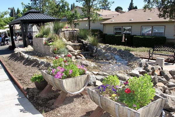 Beautiful outdoor garden area with flowers and a water feature