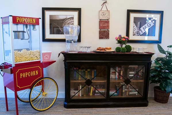 Interior view of a common area with popcorn machine and snacks