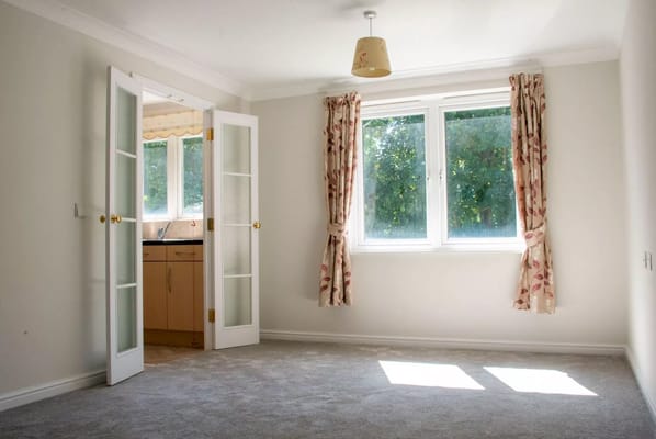 Bright interior view of a resident room with large windows
