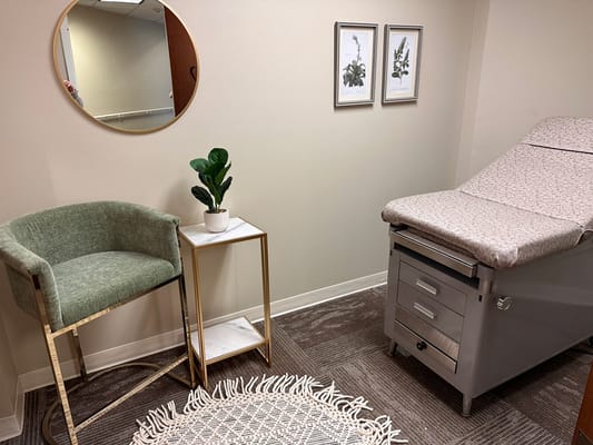 Interior view of a wellness or therapy room with a treatment table