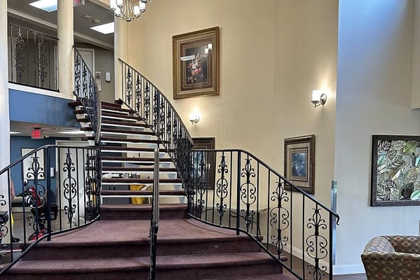 Spiral staircase with wrought iron railing in the lobby