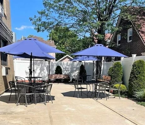 Outdoor patio area with blue umbrellas and seating