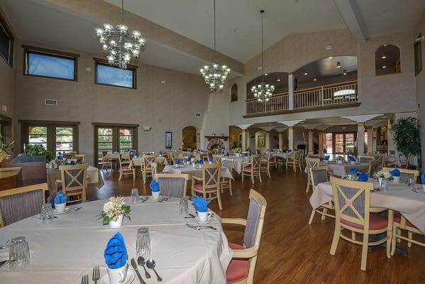 Bright dining room with tables set for a meal
