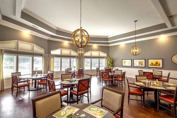 Bright dining room with modern decor and tables set for meals