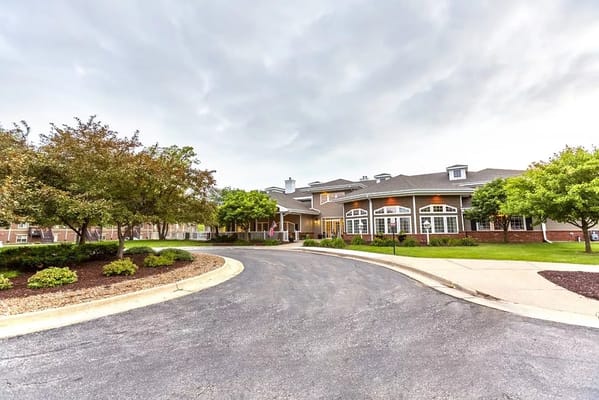Entrance driveway of Independence Village of Ames surrounded by greenery