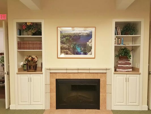 Cozy interior space with decorative shelving and fireplace