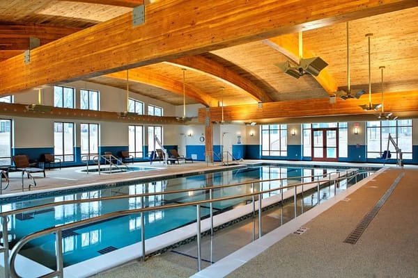 Indoor swimming pool area with wooden beams