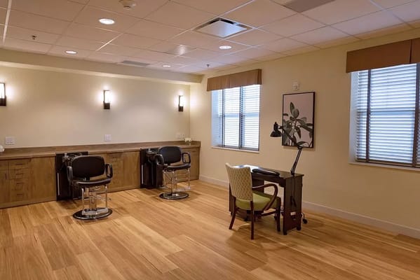 Spa treatment area with salon chairs and a desk