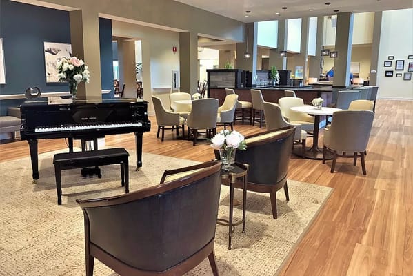Bright and inviting common area with a piano.