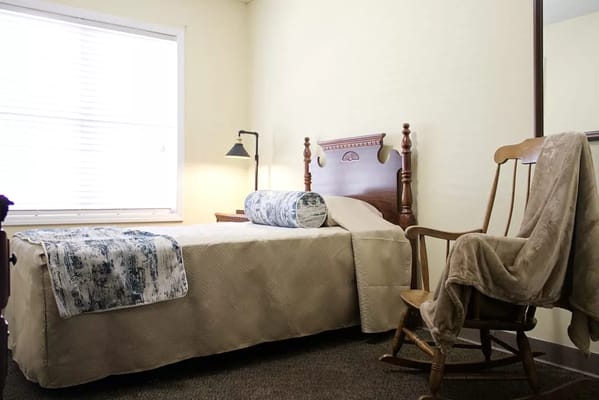 Cozy resident room with a bed and rocking chair