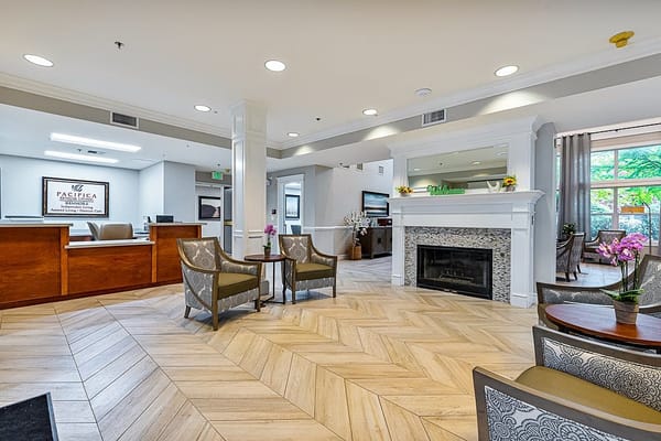Bright and modern common area with seating and fireplace
