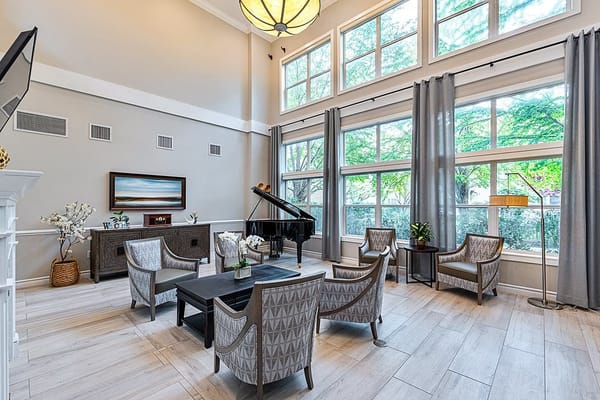 Bright common area with seating and large windows