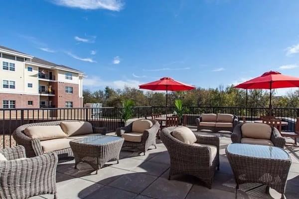 Outdoor lounge area with seating and umbrellas