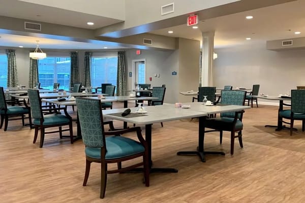 Dining room with tables and chairs set for meals