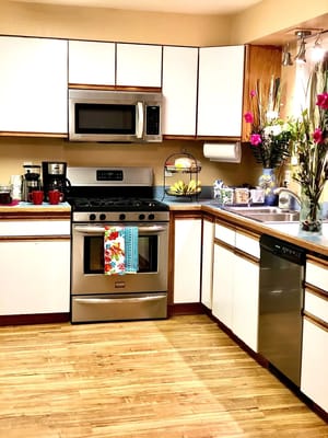 Modern kitchen with stainless steel appliances and wooden floors
