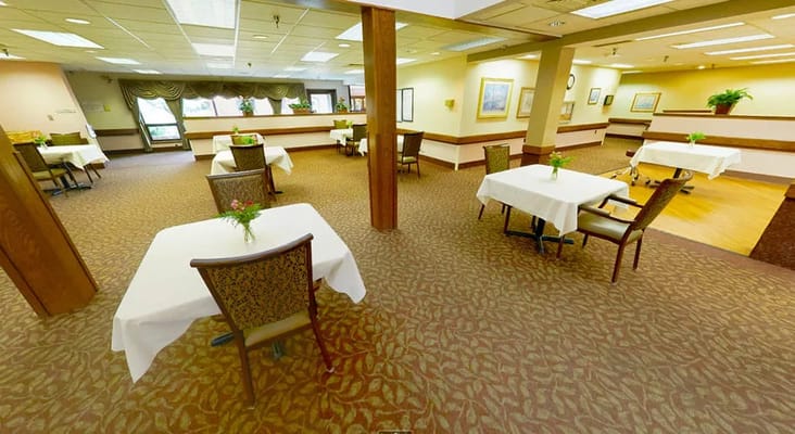 Spacious dining area with tables and chairs set for meals.