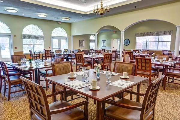 Spacious dining room with tables set for meals