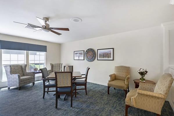 Common area with seating and decor in a senior living facility