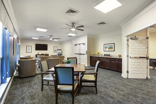 Bright common area with seating and TV