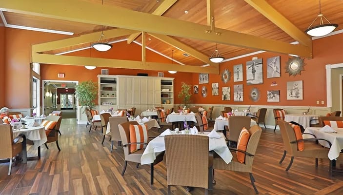 Bright dining room with tables set for residents